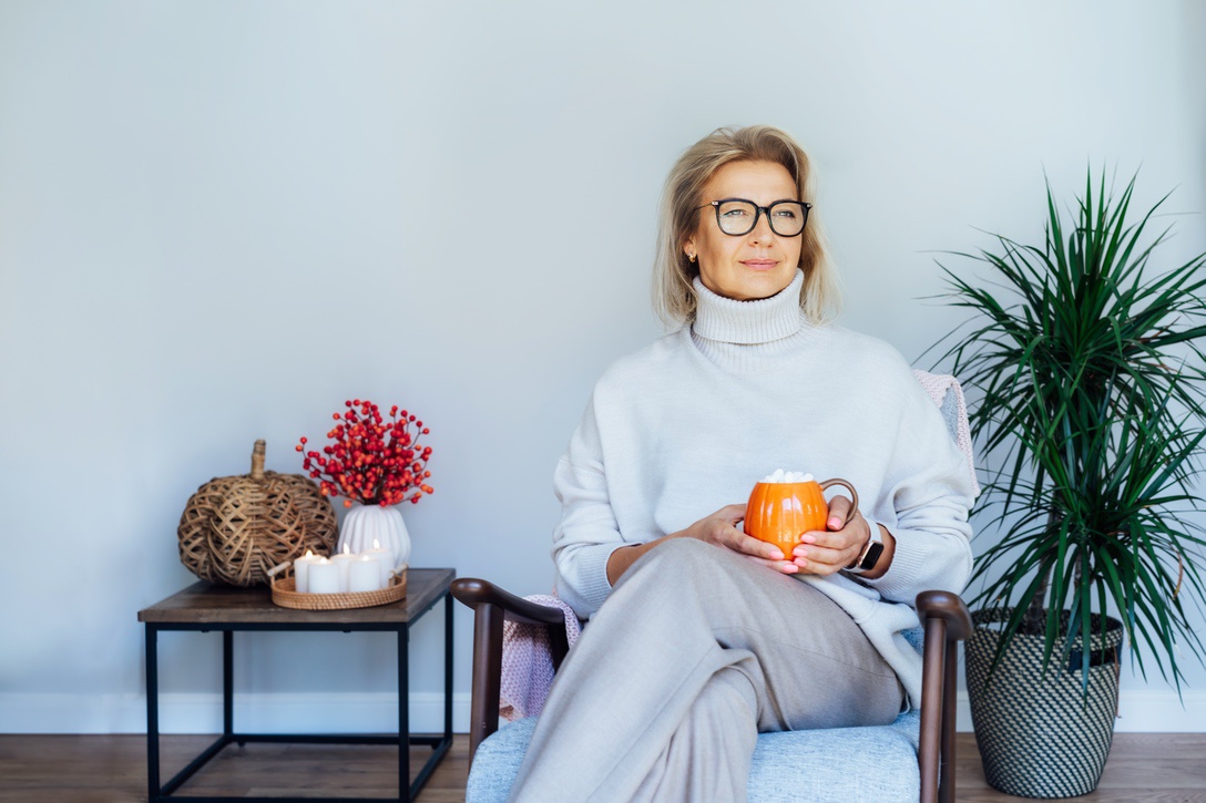Happy homeowner in living room heated by furnace with fresh filter