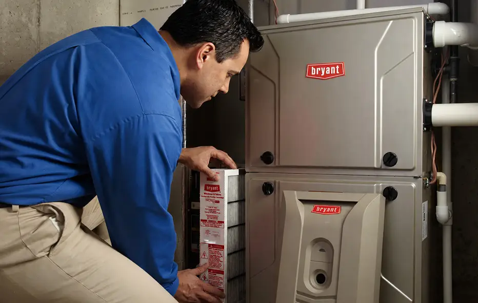 Technician replacing HVAC Filter
